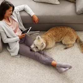Woman with pet on Carpet | Gillenwater Flooring